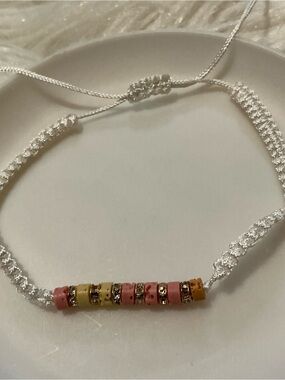 White string, pink/orange/yellow bead simplistic bracelet